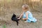 Young kind girl and black cat.