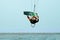 Young kitesurfer jumping in the sky on the board