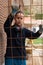 Young labourer looking at the camera in construction patio with iron mesh