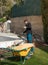 Young labourer working on a pool in a family house with a wheelbarrow and shovel