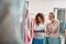 Young ladies choosing dress from bridal catalogue