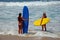 Young ladies getting ready to surf in Laguna Beach, California.