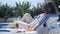 Young lady in bikini sunbathing on deck chair, enjoying vacation