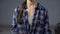 Young lady in casual clothes at home, wearing oversized man plaid shirt, fashion