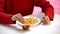 Young lady dipping french-fried potato in tomato sauce, harmful meal, calories