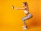 Young Lady Doing Deep Squat Exercise, Studio Shot, Side View