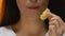 Young lady eating spicy potato chips, unhealthy snack and fast food, close up