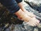 A young lady feet water relaxing rocks water flow