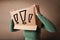 Young lady gesturing with a cardboard box on her head with exclamation point