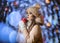 A young lady in mittens and a hat on a background of bokeh from Christmas garlands