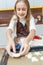 Young lady placing biscuits on a baking tray