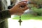 Young lady prayer hand holding rosary beads with Jesus Christ holy cross crucifix. Praying The Rosary everyday concept.