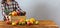 Young lady putting wooden box with fruit on the table