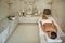 Young lady relaxing in the Turkish bath while lying on her stomach