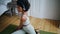 Young lady stretching body at mat indoors. Black hair woman making yoga exercise