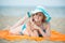 Young lady sunbathing on a beach. Beautiful woman posing at the