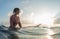 Young lady surfer waits the waves