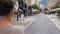 Young lady walking along street with shops, looking for sales, European city