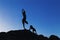 Young lady in yoga position with dog on the rocks