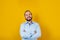 Young latin bearded business man wearing formal clothes smiling at camera in yellow background in Mexico Latin America