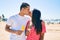 Young latin couple  holding ice cream and kissing  at the beach