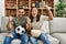 Young latin couple watching soccer match eating porpcorn at home