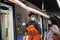 Young latin couple wearing protective face mask going inside the train, metro, subway