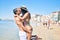 Young latin couple wearing swimwear  walking and kissing at the beach