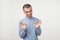 A young latin handsome man in blue shirt isolated on gray background showing ok sign.