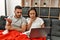 Young latin ill couple having medical teleconsultation using laptop at home