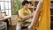 Young latin man artist sitting on chair drawing at art studio