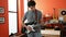 Young latin man musician playing electrical guitar standing at music studio