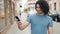 Young latin man smiling confident making selfie by the smartphone at street