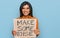 Young latin transsexual transgender woman holding make some noise banner looking positive and happy standing and smiling with a