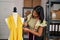 Young latin woman dressmaker choosing color thread at designer studio