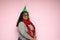 Young latin woman with overweight body positive shows her enthusiasm and happiness for the arrival of december and celebrating chr