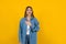 Young latin woman practicing breathing or breaths fresh air with closed eyes on yellow background in Mexico Latin America