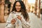 Young latin woman smiling happy counting colombia pesos banknotes at the city