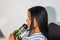 Young Latina drinking from a green sports water bottle