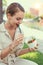 Young latina woman eating salad in park