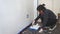 Young lating woman painting a wall in her apartment