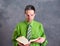 Young lawyer in green shirt with statute book and pink glasses