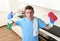 Young lazy house cleaner man washing and cleaning the kitchen with detergent spray bottle