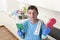 Young lazy house cleaner man washing and cleaning the kitchen with detergent spray bottle