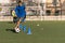 young left-footed player dribbles cones out cones with a football