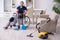 Young leg injured contractor in wheel-chair cleaning the house