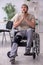 Young leg injured man in wheel-chair