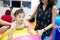 Young little Asian baby enjoy playing on colorful ball in kid playground.