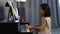 Young little asian girl playing  piano .