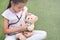 Young little asian girl playing pretend to be a doctor. young girl eaxamine her teddy bear with stethoscope